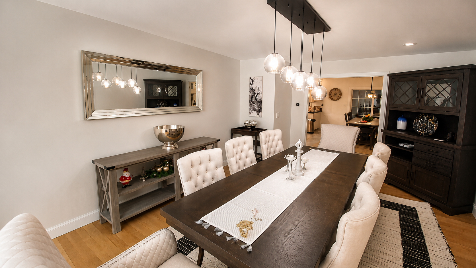 Elegant formal dining room at The Estate at Rebecca's Fountain featuring seating for eight, custom lighting, designer furnishings and luxury finishes.
